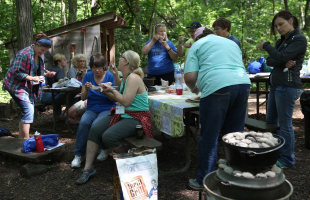 Women taste pasta and some desserts they created in cast-iron Dutch ovens, during Becoming an Outdoors Woman Workshop at Lorado Taft Campus in 2015. (Abel Uribe/Chicago Tribune)