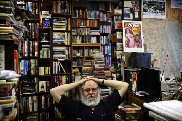 Bill Fiedler sits in 2010 at the checkout counter of The Gallery Bookstore, the store he owned on Belmont Avenue in Lakeview. He recently closed the store, but contrary to some reports, he did not die. (William DeShazer/Chicago Tribune)