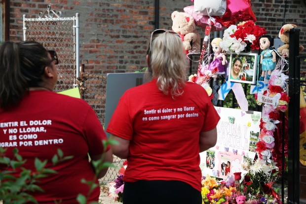 In memory of Karina Gonzalez and her daughter, who were allegedly killed by Gonzalez's husband, mourners gather in the 2600 block of South Millard Avenue in Chicago on TJuly 6, 2023. Speakers denounced domestic violence and urged attendees to ask for help if they are suffering from domestic violence. (Terrence Antonio James/Chicago Tribune)