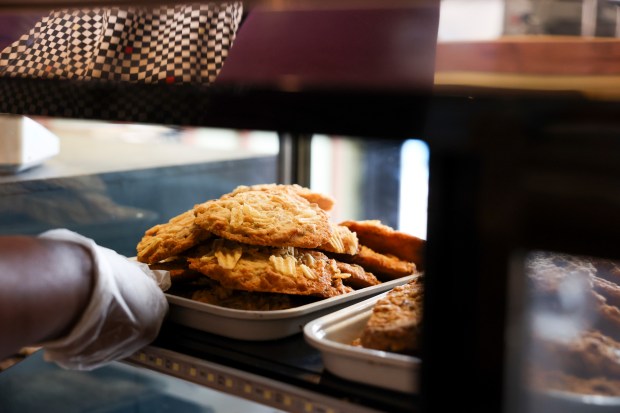 Lenore Lindsey sets potato chip cookies on a shelf in the family-owned bakery. (Eileen T. Meslar/Chicago Tribune)