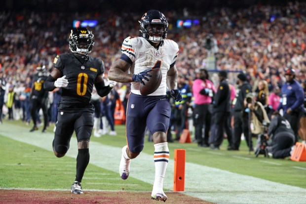 The Bears' D'Andre Swift scores on a 56-yard touchdown run in front of Commanders cornerback Mike Sainristil in the third quarter on Oct. 27, 2024, at Northwest Stadium in Landover, Md. (Brian Cassella/Chicago Tribune)