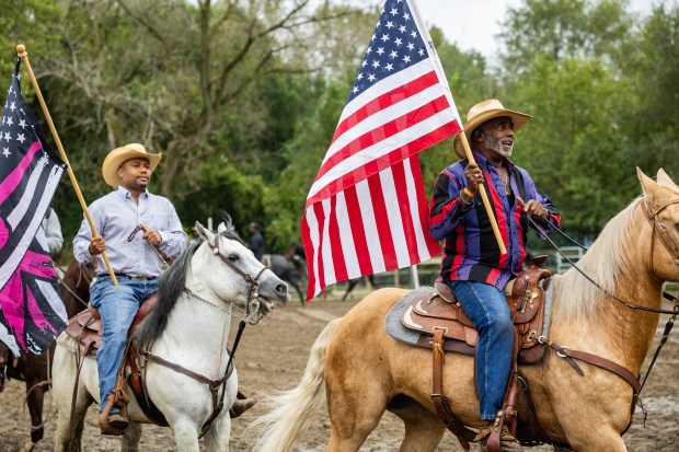 Kent Walker, from Gary, Indiana, right, rides in the 9th Annual Rodeo at Brown Family Ranch, a Black-owned ranch that has been operating for more than 50 years in Gary, Indiana, on Sept. 28, 2024. (Tess Crowley/Chicago Tribune)