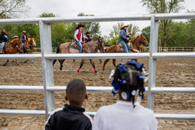 Spectators watch the 9th Annual Rodeo at Brown Family Ranch, a Black-owned ranch that has been operating for more than 50 years in Gary on Sept. 28, 2024. (Tess Crowley/Chicago Tribune)