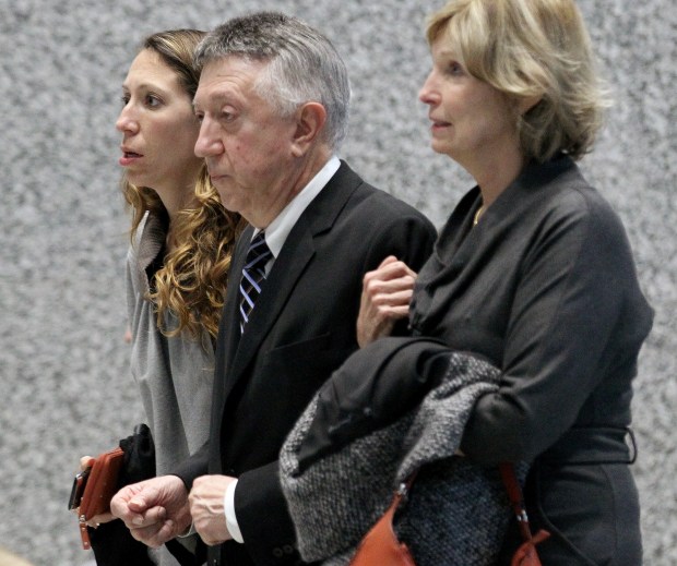 Springfield powerbroker William Cellini leaves the Dirksen U.S. Courthouse flanked by wife Julie, right, and daughter Claudia after his sentencing Oct. 4, 2012. (Antonio Perez/Chicago Tribune)