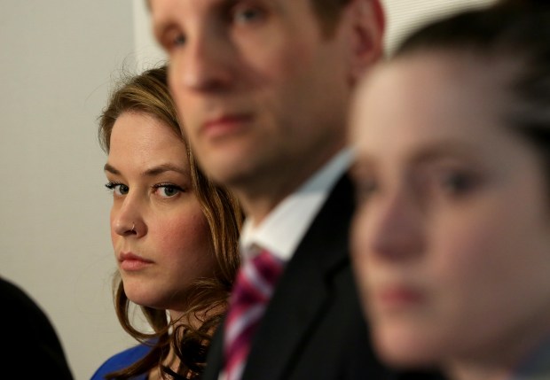 Alaina Hampton, left, stands with attorneys on March 22, 2018, in Chicago as they announce a federal lawsuit against the Illinois Democrats and then-Speaker Michael Madigan. (Nancy Stone/Chicago Tribune)