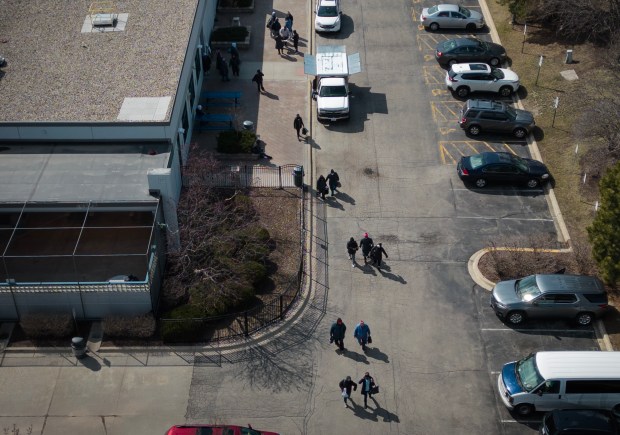 People walk outside the Hearthside Food Solutions facility in Romeoville, March 28, 2023. (E. Jason Wambsgans/Chicago Tribune)