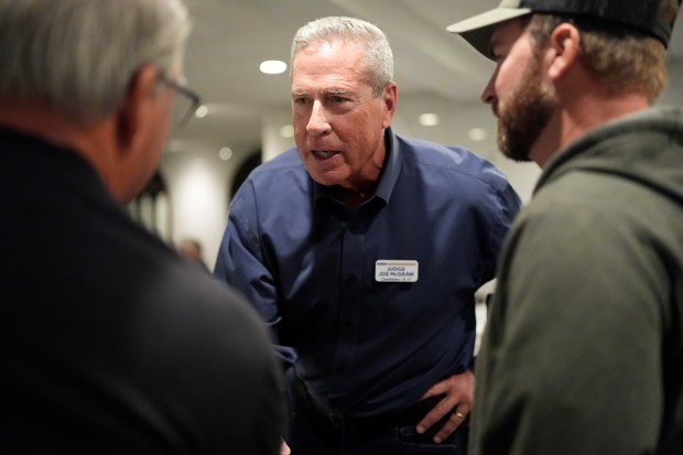 Retired judge Joe McGraw, the Republican challenger in the 17th District, talks with Homebuilders Association members at Lino's restaurant in Rockford, Oct. 17, 2024. (Nam Y. Huh/AP)