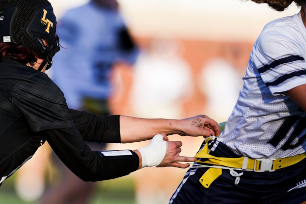 Lane Tech player Florencia Fabian grabs an opponent's flag during the sectional championship game against Jones College Prep at Winnemac Stadium on Oct. 16, 2024. (Eileen T. Meslar/Chicago Tribune)