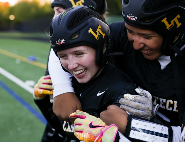 Lane Tech player Vanessa Ramirez, right, hugs teammate Lila Massey after she scored the game-winning touchdown in overtime in the sectional championship game against Jones College Prep at Winnemac Stadium on Oct. 16, 2024. (Eileen T. Meslar/Chicago Tribune)