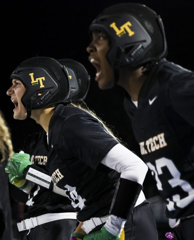 Lane Tech players Gianna Phillips, second from right, and Makayla Brown cheer on their defense during their quarterfinal game at Willowbrook High School in Villa Park on Oct. 18, 2024. (Eileen T. Meslar/Chicago Tribune)