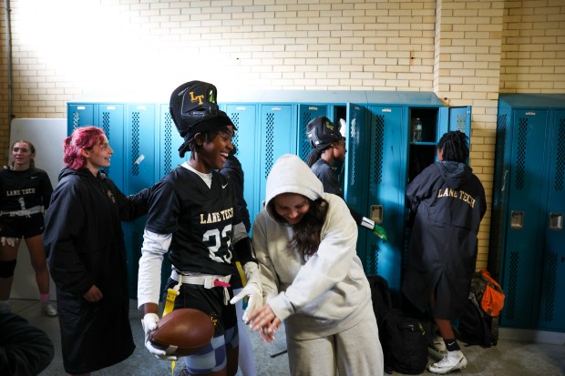 Lane Tech's Makayla Brown (23) and team manager Sophie Montes goof around before their first sectional game against Morton High School at Winnemac Stadium on Oct. 15, 2024. (Eileen T. Meslar/Chicago Tribune)