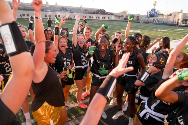 Coach Caroline Schwartz and her players do their team cheer after they won their game against Whitney Young at Lane Stadium on Sept. 20, 2024. (Eileen T. Meslar/Chicago Tribune)