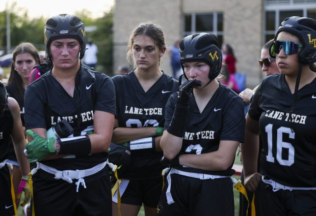 Lane Tech players listen to Coach Caroline Schwartz after their 32-0 loss to Taft at Resurrection College Prep High School on Sept. 11, 2024. (Eileen T. Meslar/Chicago Tribune)