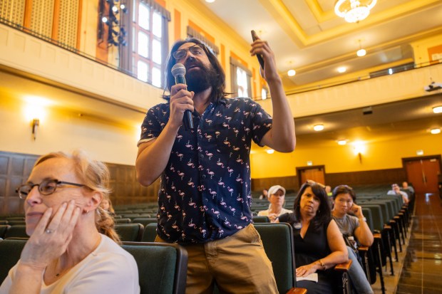 The parent of a child in Chicago Public Schools and resident of District 4 Angel Alvarez asks the candidates a question at Lane Tech College Prep High School in Chicago on Oct. 5, 2024. (Tess Crowley/Chicago Tribune)