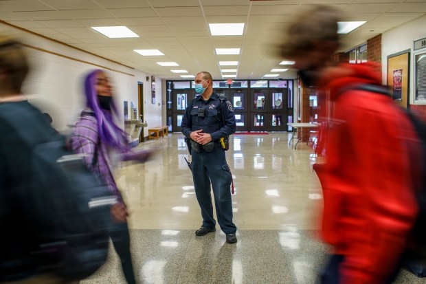 School resource officer Roger Tambling watches students walk between periods at Bradley-Bourbonnais Community High School in 2022, in Bradley, Illinois. (Armando L. Sanchez/Chicago Tribune)