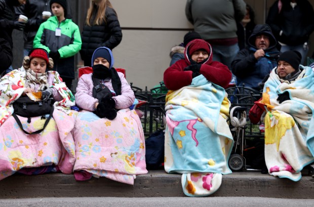 People are wrapped up for the cold weather as they watch the 90th Chicago Thanksgiving Parade on Nov. 28, 2024. (Antonio Perez/Chicago Tribune)