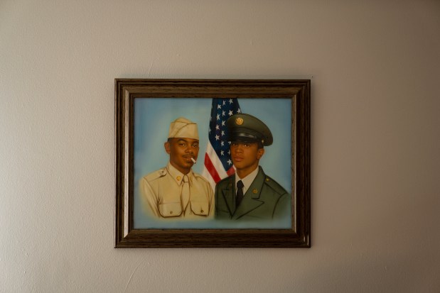 A portrait Louis Smith had painted of himself and his father, left, in the late 90s when he was serving in the Army in Korea. (E. Jason Wambsgans/Chicago Tribune)