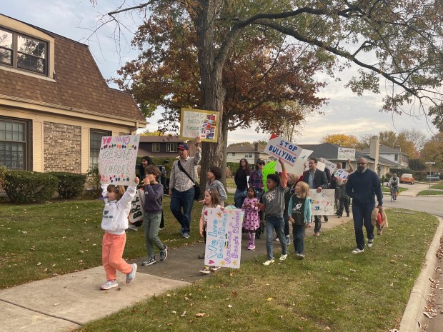 About 100 Dr. Bessie Rhodes School of Global Studies students and their family members participated in a protest march on Oct. 28 over the suddenly announced closure for 7th and 8th grade at the school for Nov. 15. The entire school is expected to close during the summer of 2026. (Richard Requena/Pioneer Press)