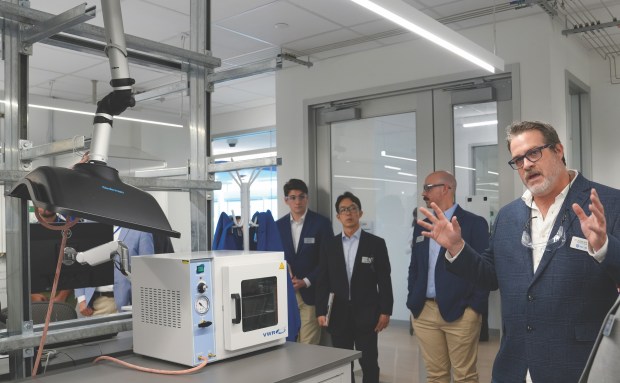 Jorge González, at right, director of research at Materials Discovery Research Institute at Skokie's Science and Technology Park, describes specialist adsorptioninstrumentation used to understand material surfaces during a tour as MDRI scientists Conor Brew, far left, and Sung Hwan Park listen in along with UL Research Institutes' Real Estate & Facilities Program Manager Dan Barber. (MDRI)