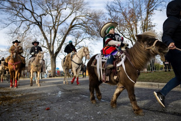 Rogelio Pinzon, 18 mo., a rider from Club Los Vaqueros Unidos, finishes the Archdiocese of Chicago's 13th Annual Horseback Pilgrimage in Honor of Our Lady of Guadalupe at the Shrine of Our Lady of Guadalupe in Des Plaines on Dec. 7, 2024. (Tess Crowley/Chicago Tribune)