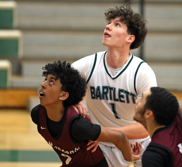 Bartlett's Colin Taylor (1) and Elgin's Ryan Varghese (2) battle under the board in the first quarter during an Upstate Eight Conference game in Bartlett on Friday, Dec. 13, 2024.(H. Rick Bamman/for the Beacon-News)