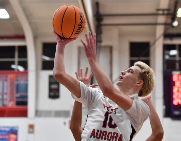 West Aurora's Kael Adkins puts up a shot during a game against East Aurora on Friday, Dec. 20, 2024 in Aurora...(Jon Cunningham/for The Beacon-News)