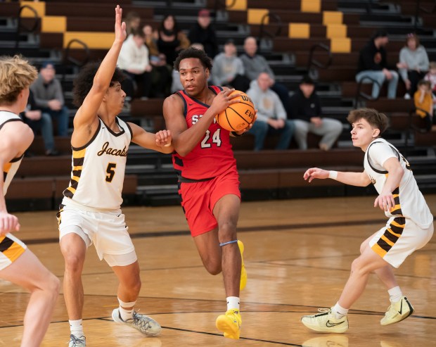 South Elgin's Ishmael George drives to the basket past Jacobs' Jordan O'Connor during their game in the 2024 Hinkle Holiday Classic basketball tournament at Jacobs High School in Algonquin on Saturday, Dec. 21, 2024. (Ryan Rayburn/for the Aurora Beacon News)