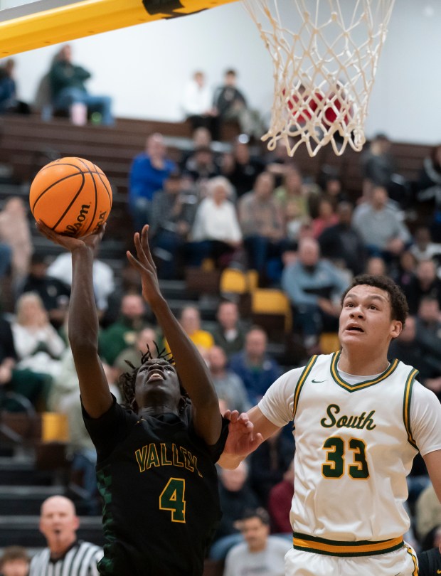 Waubonsie Valley's Moses Wilson shoots as he is guarded by Crystal Lake South's Cooper Buelna during the championship game of the 2024 Hinkle Holiday Classic basketball tournament at Jacobs High School in Algonquin on Friday, Dec. 27, 2024. (Ryan Rayburn/for the Aurora Beacon News)