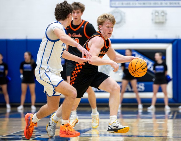 St. Charles East's Gavin Szerlong (10) dribbles around St. Charles North during a game in St. Charles on Friday, Dec. 20, 2024. (Nate Swanson / for the Beacon-News)