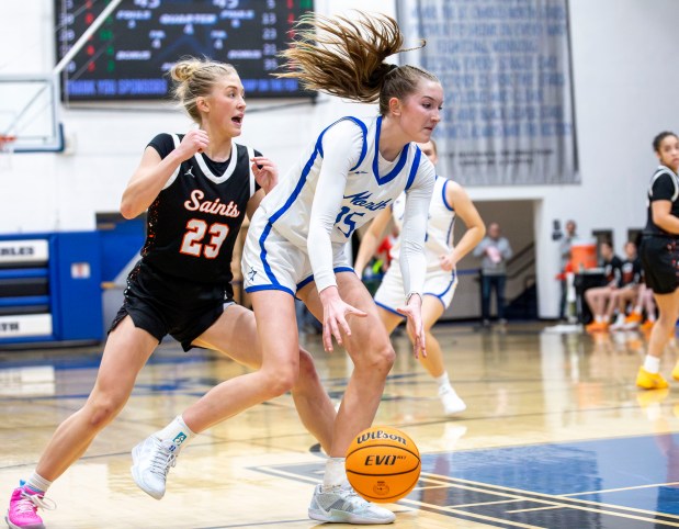 St. Charles North's Bronwyn How (15) dribbles toward the basket during a game in St. Charles on Friday, Dec. 20, 2024. (Nate Swanson / for the Beacon-News)