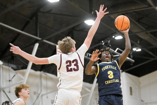 Yorkville Christian's Jayden Riley (3) takes a shot over Wheaton Academy's Hayden Schroeder (23) during a game in West Chicago on Monday, Dec. 9, 2024. (Mark Black / for the Beacon-News)