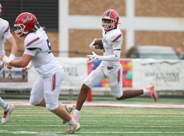 West Aurora wide receiver Terrence Smith (1) runs for a gain during a Class 8A second-round game at Maine South High School in Park Ridge on Saturday, Nov. 9, 2024. (Talia Sprague / Beacon News)