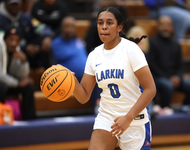 Larkin's Mia Carter (0) drives the lane against East Aurora in the third quarter during a Upstate Eight conference game in Elgin on Thursday, Dec. 5, 2024.(H. Rick Bamman/for the Beacon-News)