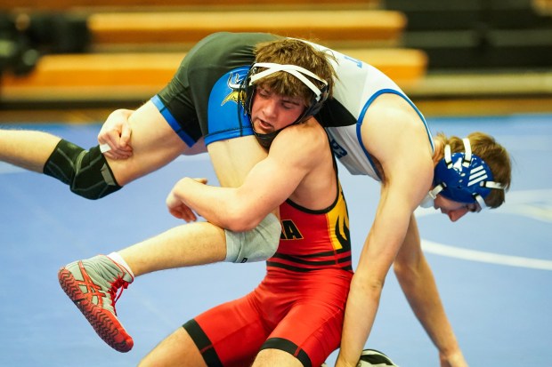 Batavia's Kyle Pasco shoots the legs of Geneva's Andrew Wendt in their 130 pound bout during a wrestling meet at Geneva High School on Thursday, Dec. 19, 2024. (Sean King / for The Beacon-News)