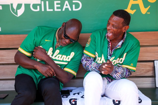 A's legends Dave Stewart and Rickey Henderson share a moment in the dugout before the team's last game at the Oakland Coliseum on Sept. 26, 2024. (Ray Chavez/Bay Area News Group)