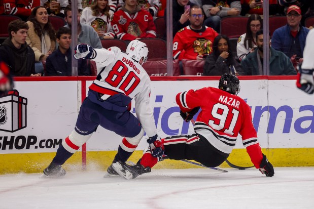 Washington Capitals left wing Pierre-Luc Dubois (80) trips Chicago Blackhawks center Frank Nazar (91) during the first period at the United Center Tuesday Dec. 17, 2024, in Chicago. (Armando L. Sanchez/Chicago Tribune)