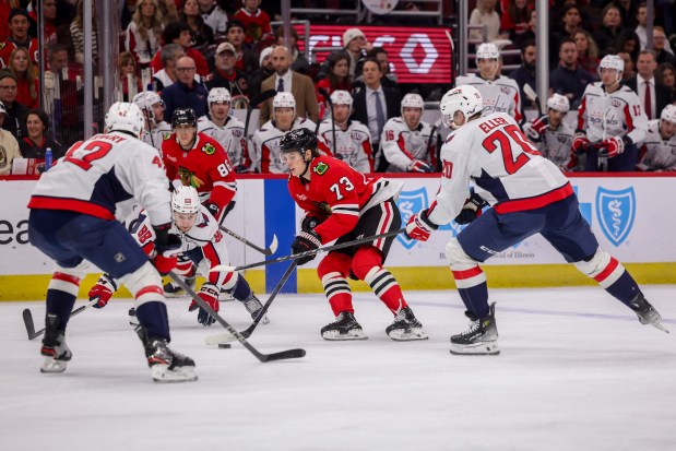 Washington Capitals center Lars Eller (20) guards Chicago Blackhawks left wing Lukas Reichel (73) while he handles the puck during the first period at the United Center Tuesday Dec. 17, 2024, in Chicago. (Armando L. Sanchez/Chicago Tribune)