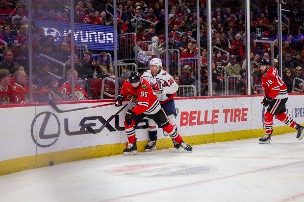 Chicago Blackhawks right wing Ilya Mikheyev (95) and Washington Capitals defenseman Rasmus Sandin (38) chase after the puck during the first period at the United Center Tuesday Dec. 17, 2024, in Chicago. (Armando L. Sanchez/Chicago Tribune)