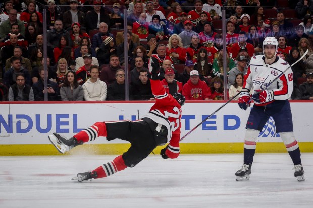 Chicago Blackhawks defenseman Alex Vlasic (72) falls on the ice during the second period against the Washington Capitals at the United Center Tuesday Dec. 17, 2024, in Chicago. (Armando L. Sanchez/Chicago Tribune)