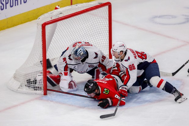 Chicago Blackhawks center Ryan Donato (8) scores a goal past Washington Capitals goaltender Logan Thompson (48) to give the Blackhawks a 3-2 lead during the third period at the United Center Tuesday Dec. 17, 2024, in Chicago. (Armando L. Sanchez/Chicago Tribune)