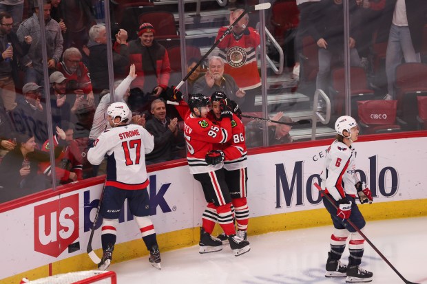 Chicago Blackhawks right wing Ilya Mikheyev (95) celebrates with Chicago Blackhawks center Teuvo Teravainen (86) after scoring a goal during the third period against the Washington Capitals at the United Center Tuesday Dec. 17, 2024, in Chicago. (Armando L. Sanchez/Chicago Tribune)