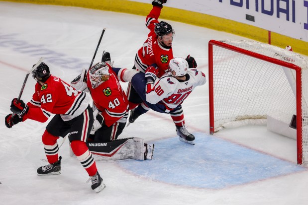 Chicago Blackhawks defenseman Connor Murphy (5) pushes Washington Capitals left wing Pierre-Luc Dubois (80) on the ice during the third period at the United Center Tuesday Dec. 17, 2024, in Chicago. (Armando L. Sanchez/Chicago Tribune)