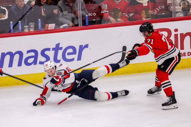 Washington Capitals left wing Ivan Miroshnichenko (63) falls on the ice during the third period against the Chicago Blackhawks at the United Center Tuesday Dec. 17, 2024, in Chicago. (Armando L. Sanchez/Chicago Tribune)