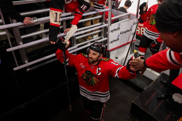 Chicago Blackhawks left wing Nick Foligno (17) high-fives fans before the Blackhawks play the Washington Capitals at the United Center Tuesday Dec. 17, 2024, in Chicago. (Armando L. Sanchez/Chicago Tribune)