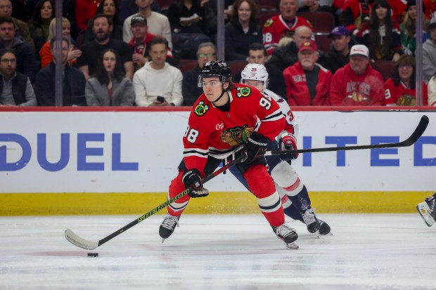 Washington Capitals defenseman Rasmus Sandin (38) guards Chicago Blackhawks center Connor Bedard (98) during the first period at the United Center Tuesday Dec. 17, 2024, in Chicago. (Armando L. Sanchez/Chicago Tribune)