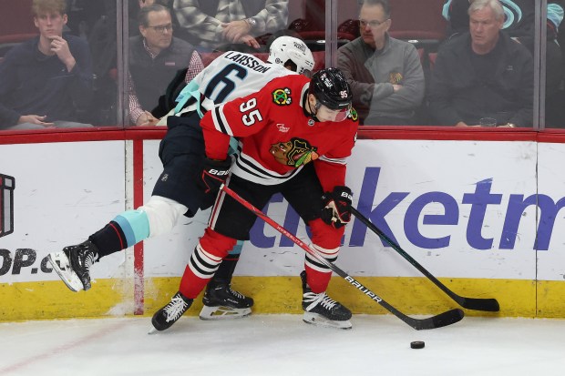 Kraken defenseman Adam Larsson (6) harasses Blackhawks right wing Ilya Mikheyev (95) in the first period at the United Center in Chicago on Dec. 19, 2024. (Terrence Antonio James/Chicago Tribune)