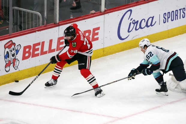 Blackhawks defenseman TJ Brodie (78) handles the puck as Kraken defenseman Brandon Montour (62) attacks in the first period at the United Center in Chicago on Dec. 19, 2024. (Terrence Antonio James/Chicago Tribune)