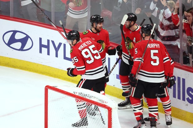 Blackhawks right wing Ilya Mikheyev (95) and his teammates celebrate his goal against the Kraken in the second period at the United Center in Chicago on Dec. 19, 2024. (Terrence Antonio James/Chicago Tribune)