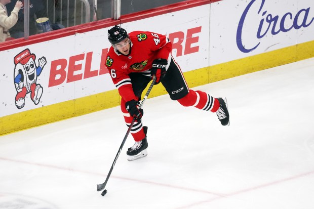 Blackhawks defenseman Louis Crevier (46) clears the puck out of the Blackhawks zone in the second period against the Kraken at the United Center in Chicago on Dec. 19, 2024. (Terrence Antonio James/Chicago Tribune)