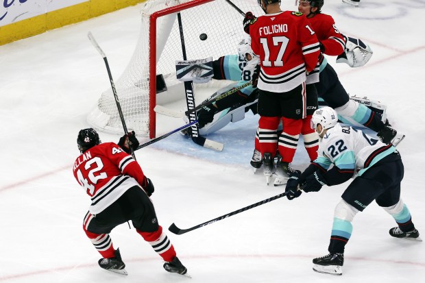 Blackhawks defenseman Nolan Allan (42) scores his first NHL goal in the third period against the Kraken at the United Center in Chicago on Dec. 19, 2024. (Terrence Antonio James/Chicago Tribune)